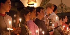 People holding a candles in church